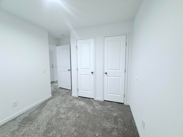 unfurnished bedroom with light colored carpet