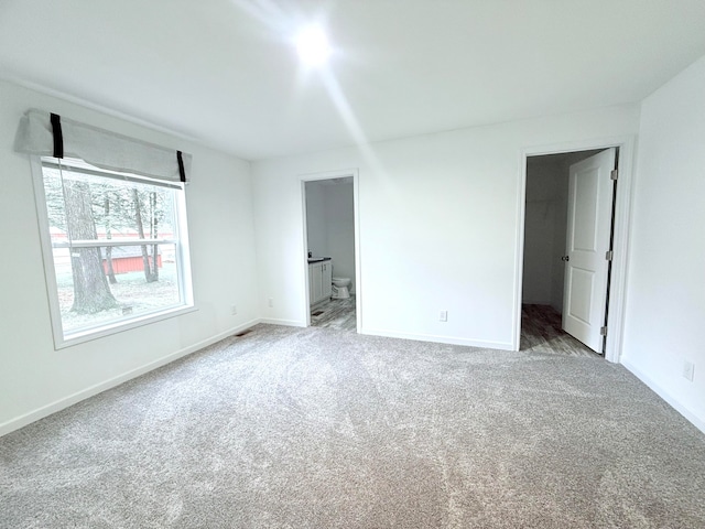 unfurnished room featuring light colored carpet