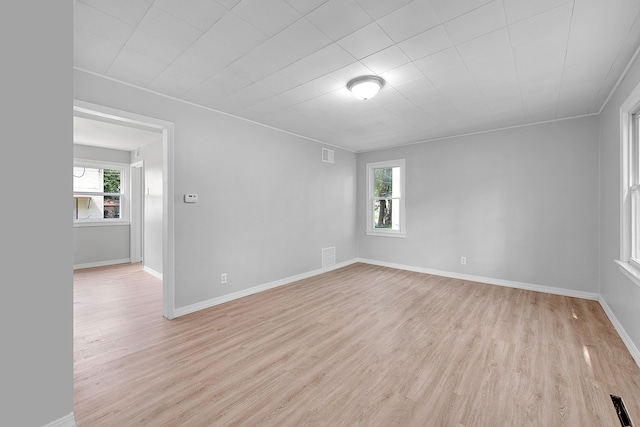 unfurnished room with a wealth of natural light and light hardwood / wood-style flooring