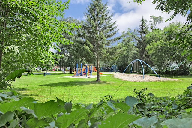 view of home's community with a lawn and a playground