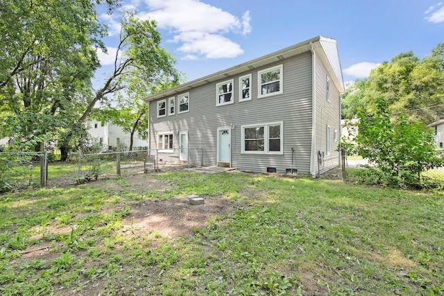 rear view of property with a lawn