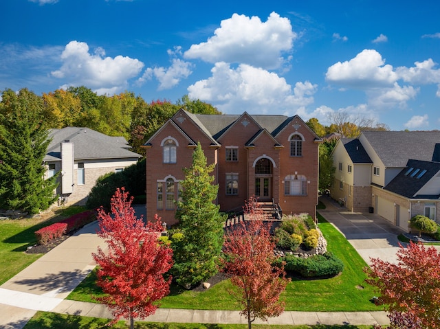 view of front of home featuring a front lawn, a garage, french doors, and brick siding