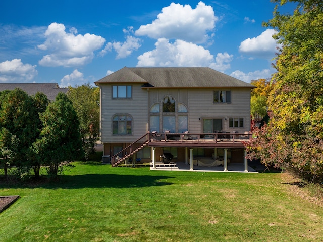 rear view of property with a patio area, stairway, a lawn, and a wooden deck