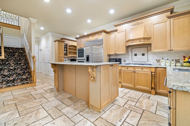 kitchen with stone tile floors, recessed lighting, premium range hood, and stainless steel appliances