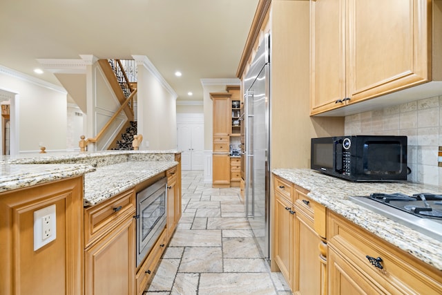 kitchen with ornamental molding, recessed lighting, built in appliances, and stone tile flooring