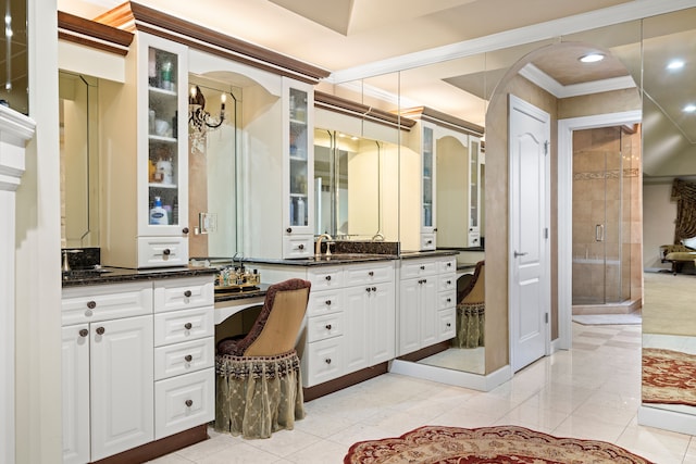 full bath featuring vanity, tile patterned floors, a stall shower, and ornamental molding