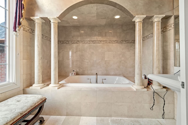 full bath with tiled bath, tile walls, recessed lighting, and ornate columns