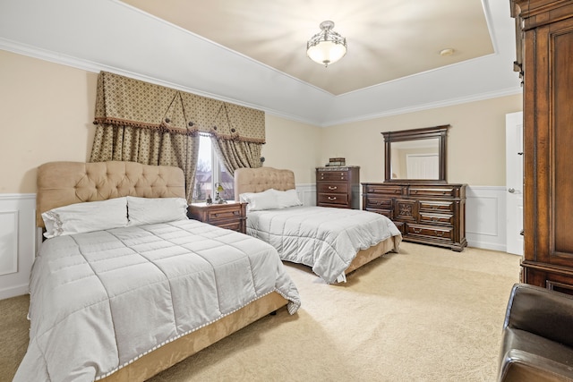 bedroom featuring light carpet, a decorative wall, wainscoting, and crown molding