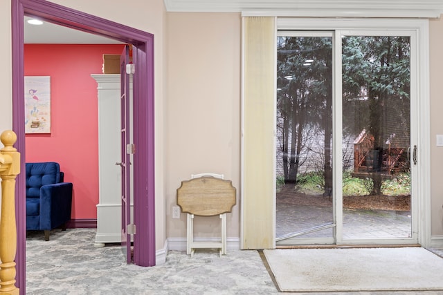 doorway featuring baseboards