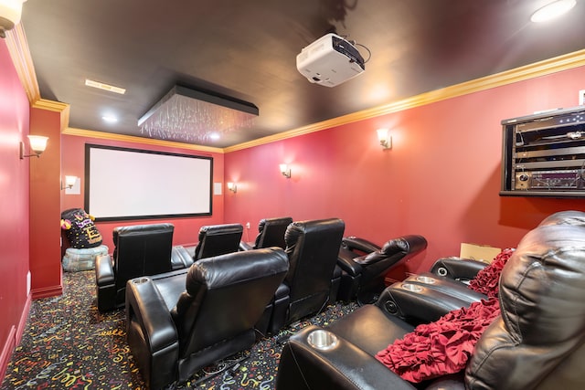 cinema room featuring baseboards, crown molding, and carpet