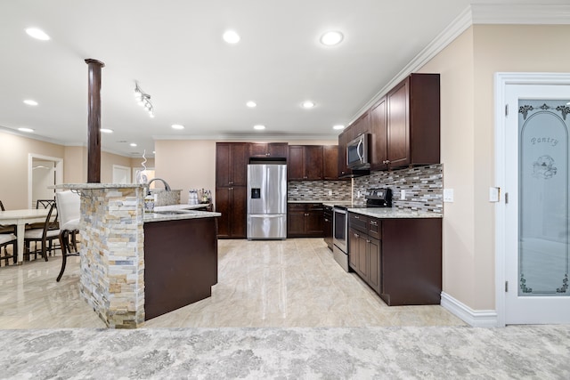 kitchen featuring dark brown cabinetry, ornamental molding, appliances with stainless steel finishes, and a sink