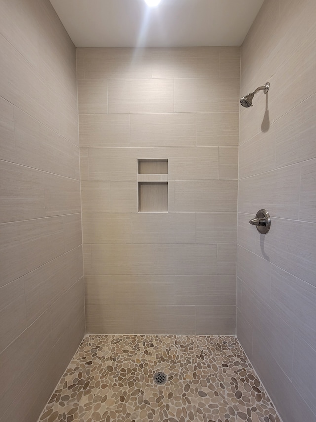 bathroom with tiled shower