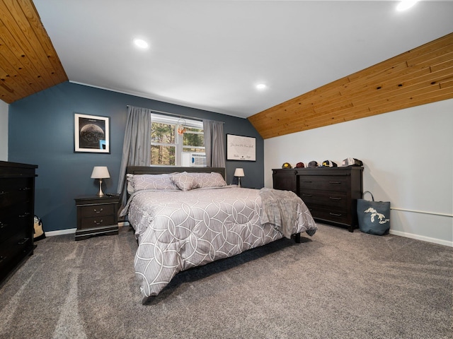 bedroom with dark colored carpet and vaulted ceiling