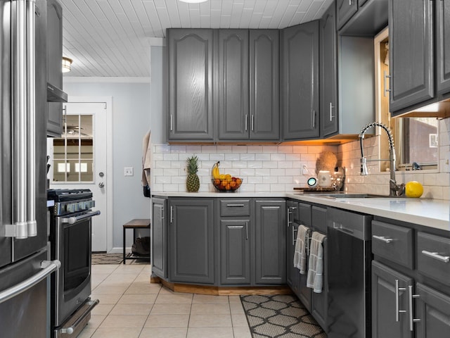 kitchen featuring stainless steel appliances, gray cabinetry, and light tile patterned flooring