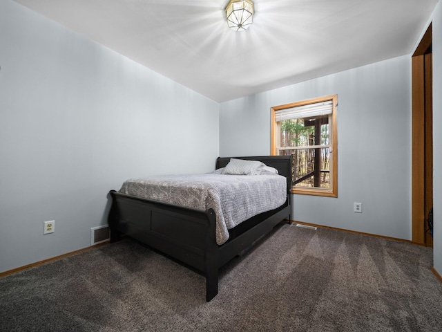 bedroom with dark colored carpet