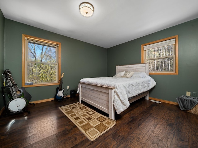 bedroom with dark hardwood / wood-style floors