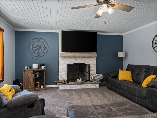 carpeted living room featuring a stone fireplace, crown molding, ceiling fan, and wood ceiling