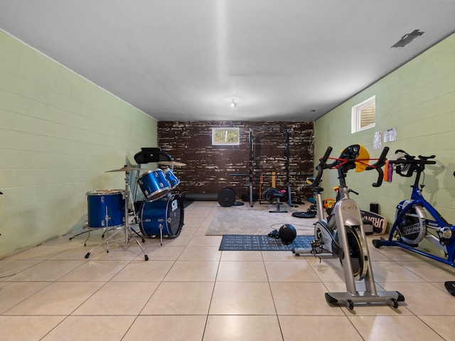 workout room with light tile patterned floors