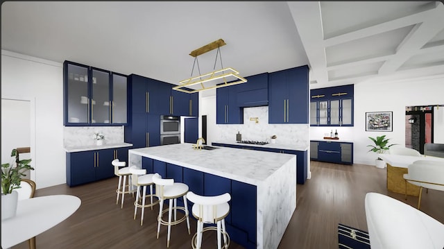 kitchen featuring pendant lighting, backsplash, a kitchen island with sink, blue cabinets, and a kitchen bar