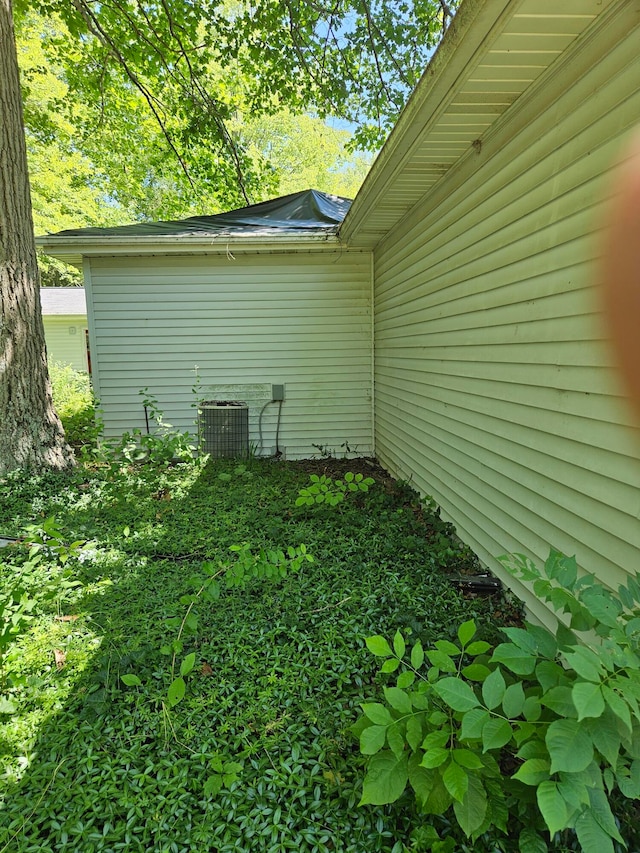 view of side of home featuring central air condition unit