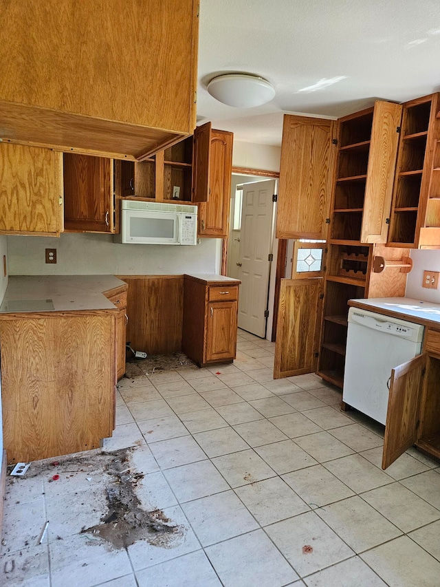 kitchen with light tile patterned flooring and white appliances