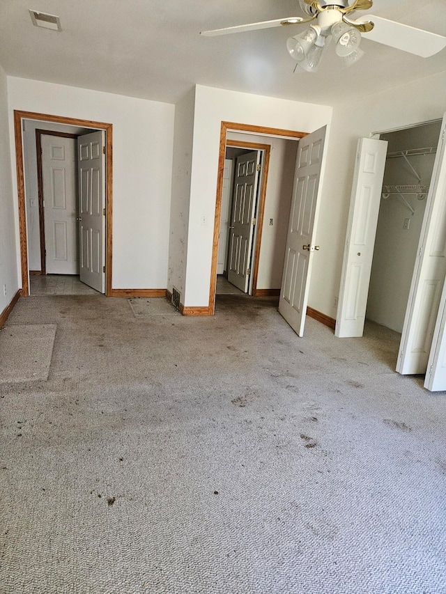 unfurnished bedroom with ceiling fan and light carpet