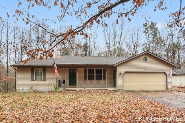 single story home featuring a porch and a garage