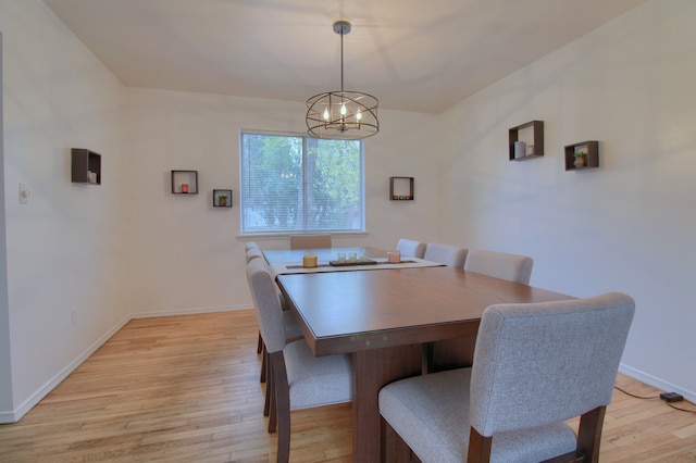 dining room featuring light hardwood / wood-style flooring and a chandelier