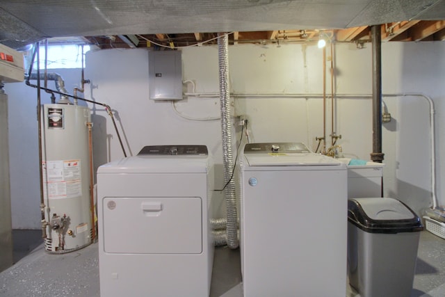 washroom featuring washing machine and dryer, gas water heater, and electric panel