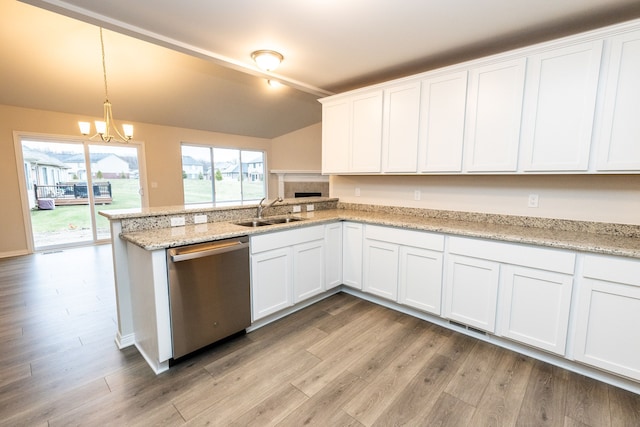 kitchen featuring dishwasher, a sink, and white cabinetry