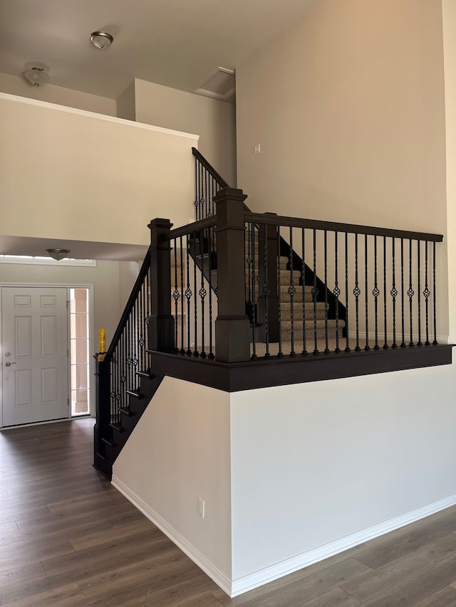 stairs featuring wood finished floors and baseboards