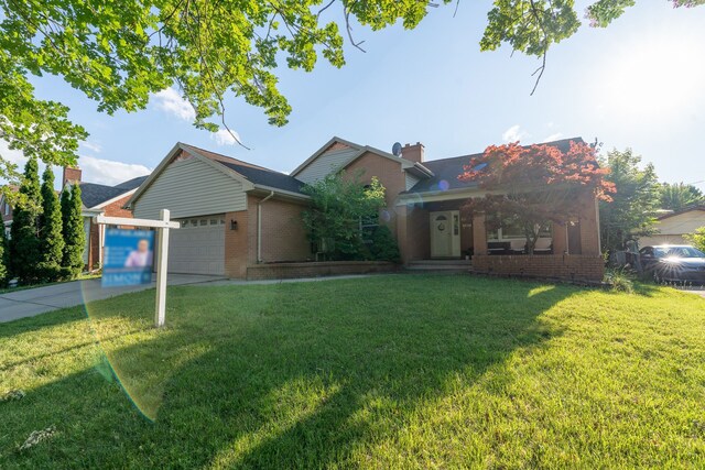 view of front of property featuring a garage and a front lawn