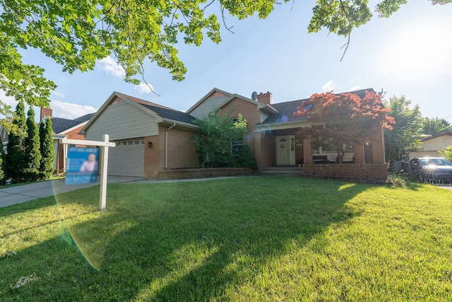 view of front facade with a garage and a front lawn