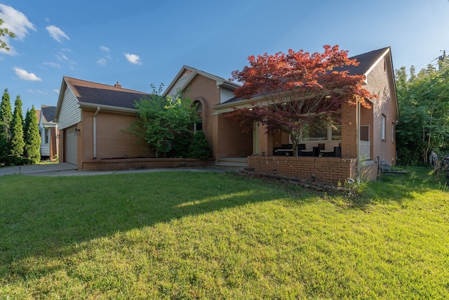 view of property hidden behind natural elements with covered porch, a garage, and a front yard