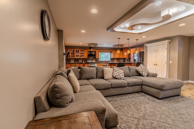 living room with a tray ceiling