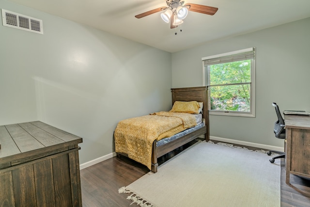 bedroom with ceiling fan and dark hardwood / wood-style floors