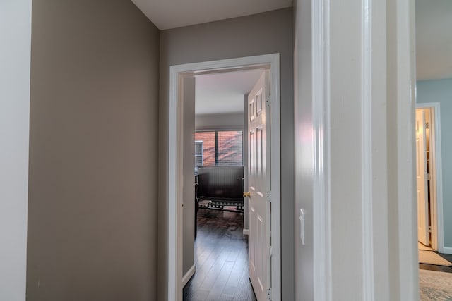 hallway with dark hardwood / wood-style floors