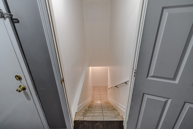 stairs featuring hardwood / wood-style floors