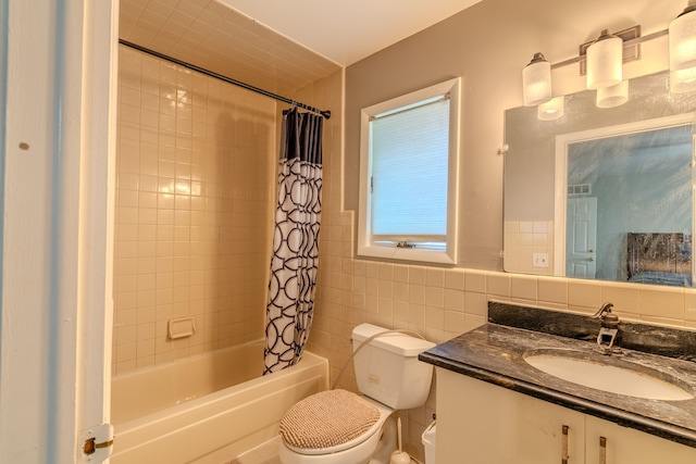 full bathroom featuring shower / bath combination with curtain, toilet, tile walls, and vanity