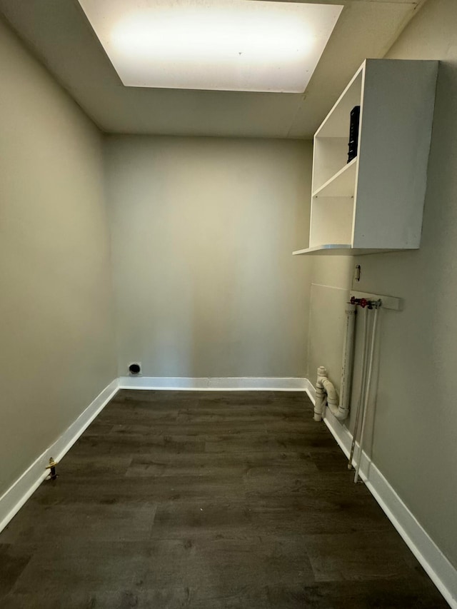 washroom featuring hookup for a washing machine and dark hardwood / wood-style flooring