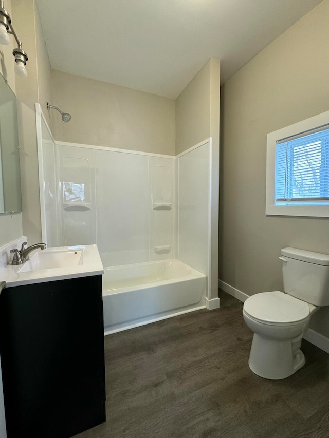 full bathroom with toilet, wood-type flooring, vanity, and bathing tub / shower combination