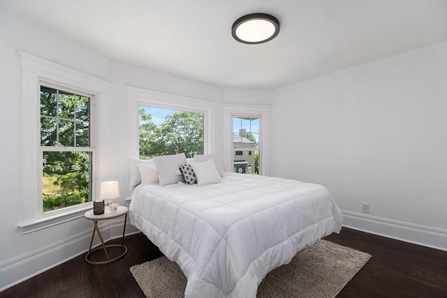 bedroom with dark hardwood / wood-style floors