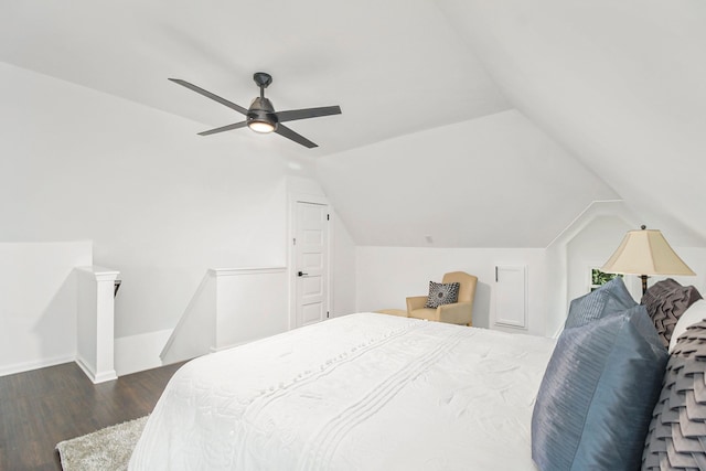 bedroom featuring dark hardwood / wood-style floors, ceiling fan, and vaulted ceiling