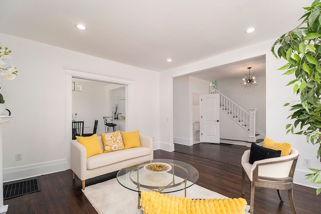 living room featuring a chandelier and dark hardwood / wood-style floors