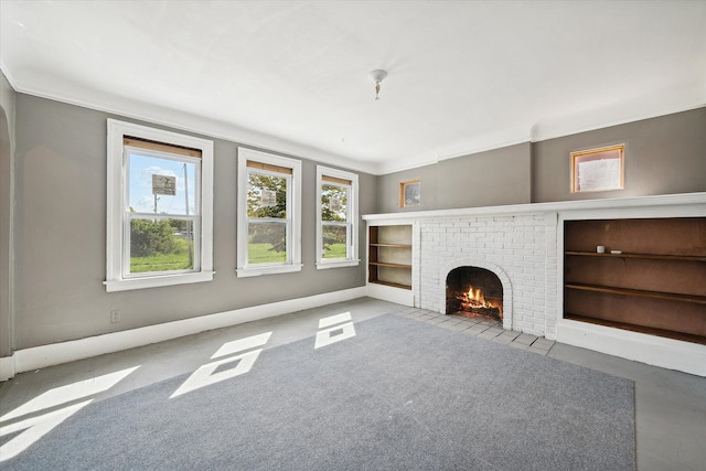 unfurnished living room with a brick fireplace and ornamental molding