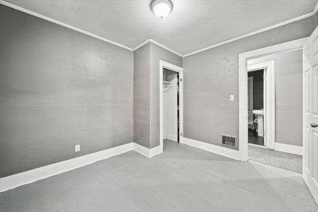 unfurnished bedroom with crown molding, baseboards, visible vents, and a closet