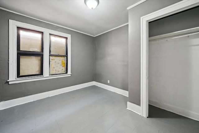 unfurnished bedroom with baseboards, a closet, and ornamental molding