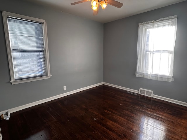 unfurnished room featuring dark wood-type flooring and ceiling fan