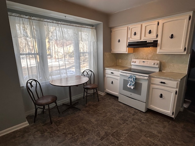 kitchen featuring tasteful backsplash, white electric range, and white cabinets