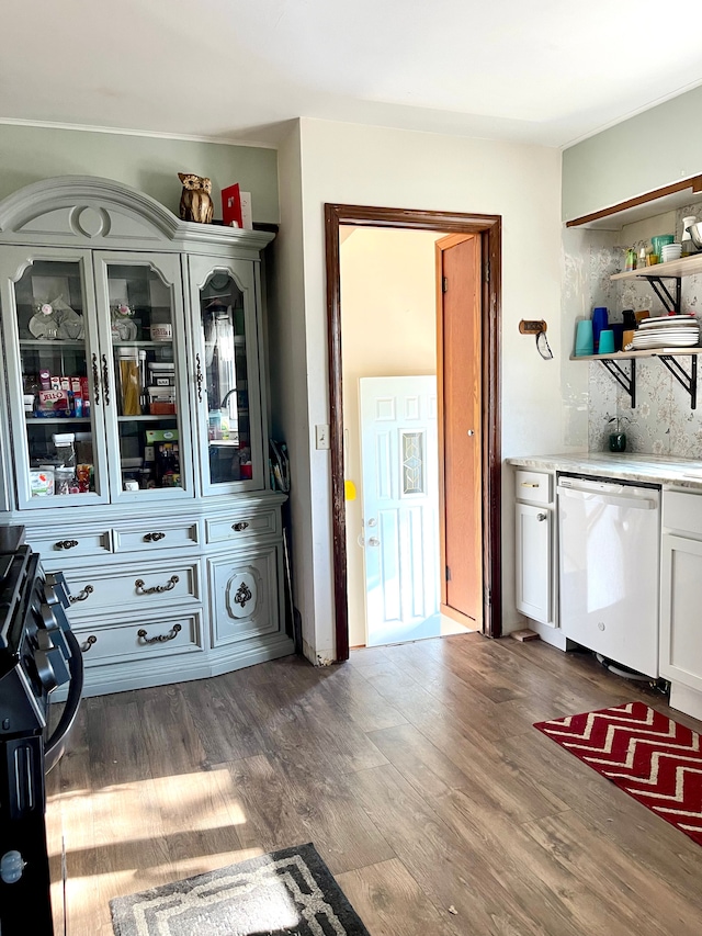 interior space featuring white dishwasher, backsplash, white cabinetry, and dark wood-type flooring